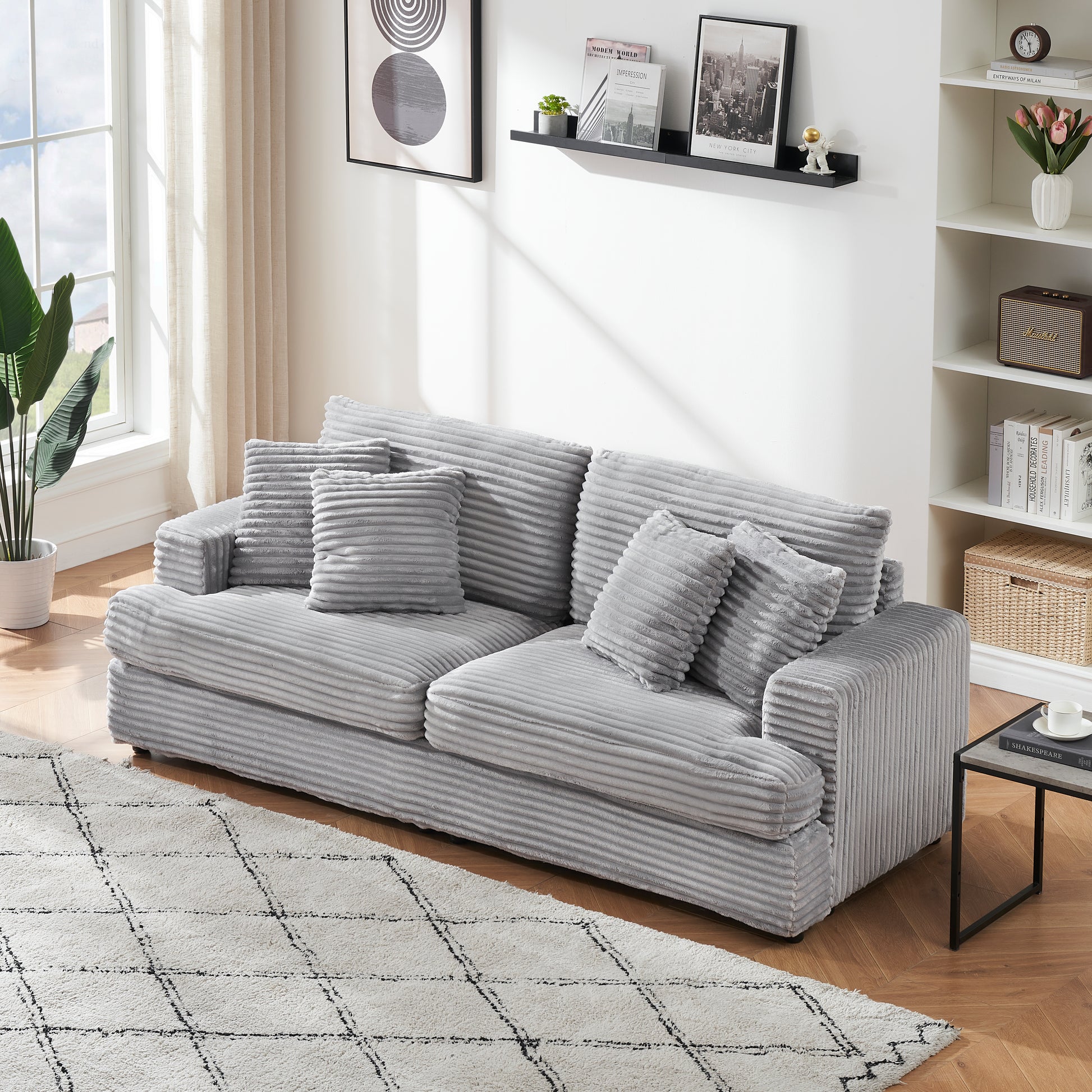 Plush grey corduroy sofa with multiple throw pillows