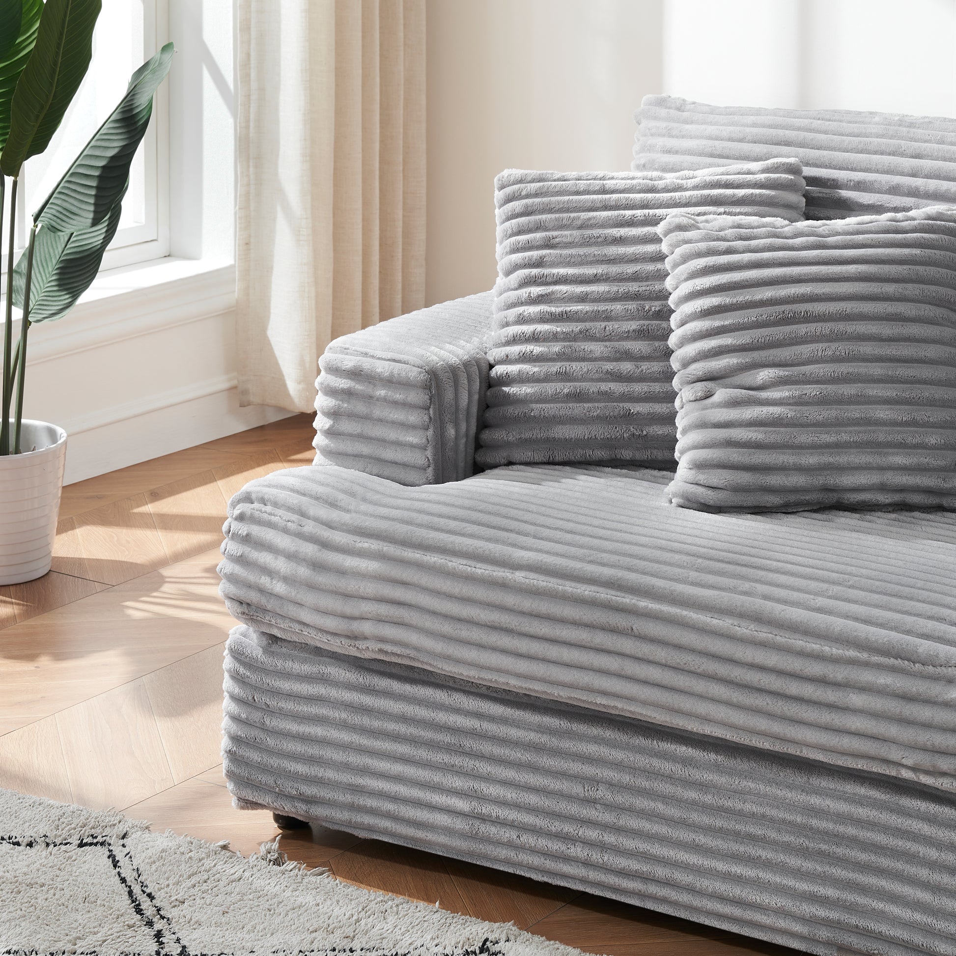 Plush grey corduroy sofa fabric texture with horizontal ridges