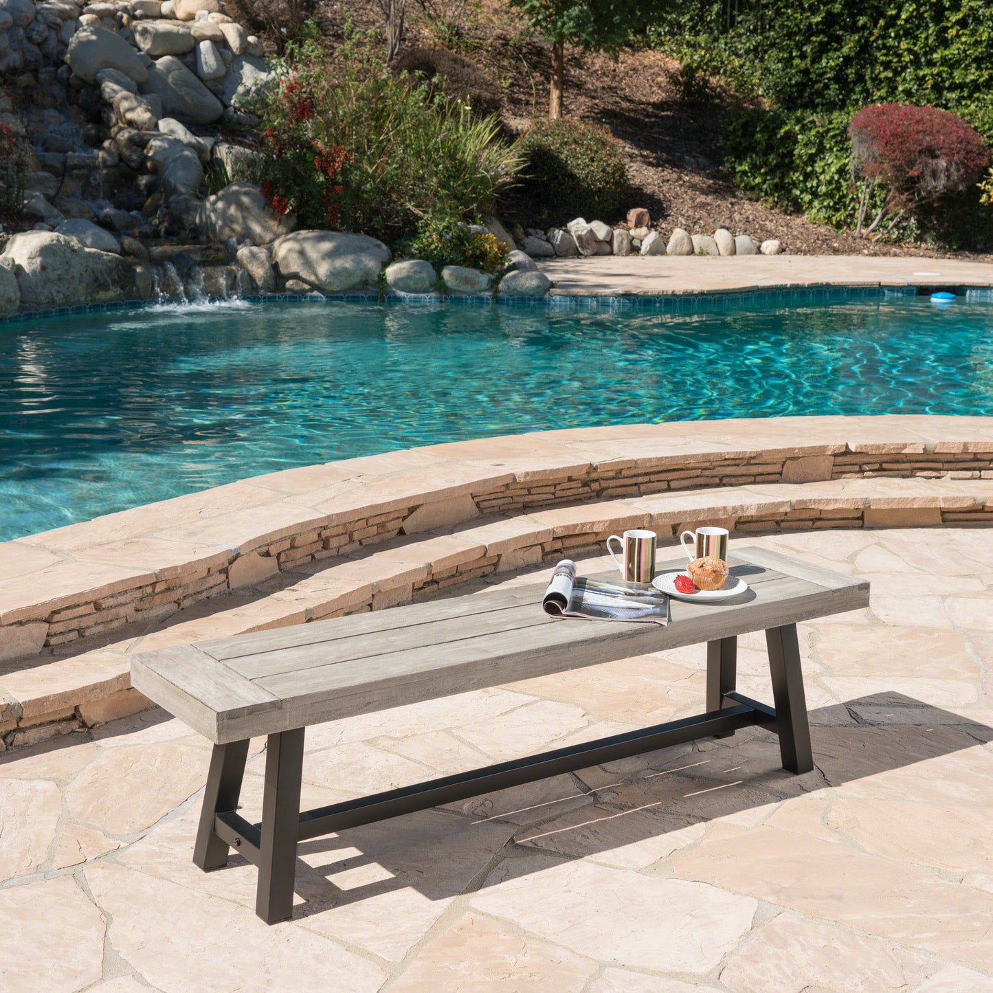 Gray wood slatted outdoor bench with black metal legs