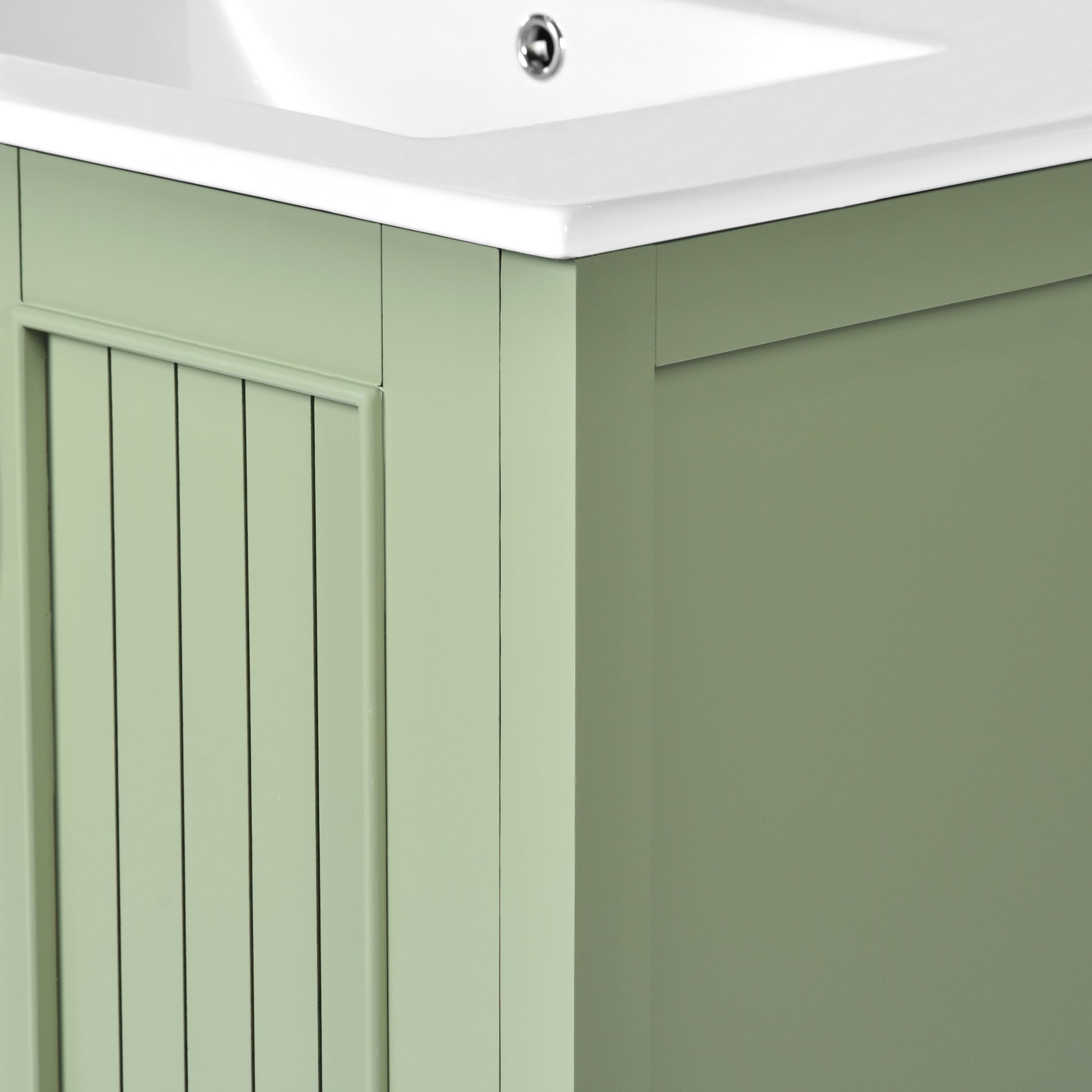 Sage green wood vanity cabinet with beaded panel detail
