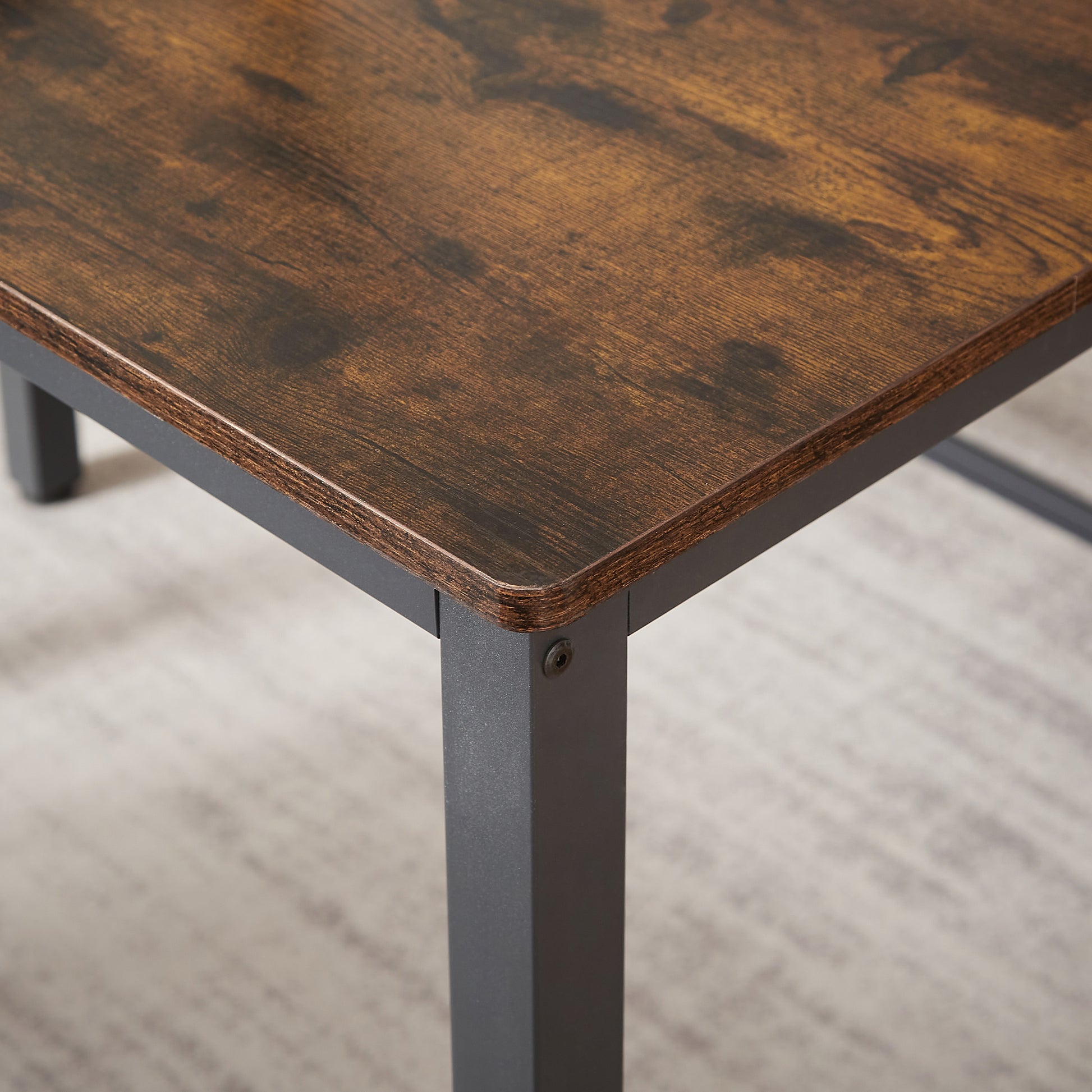 Rustic brown wood desk corner with industrial metal leg