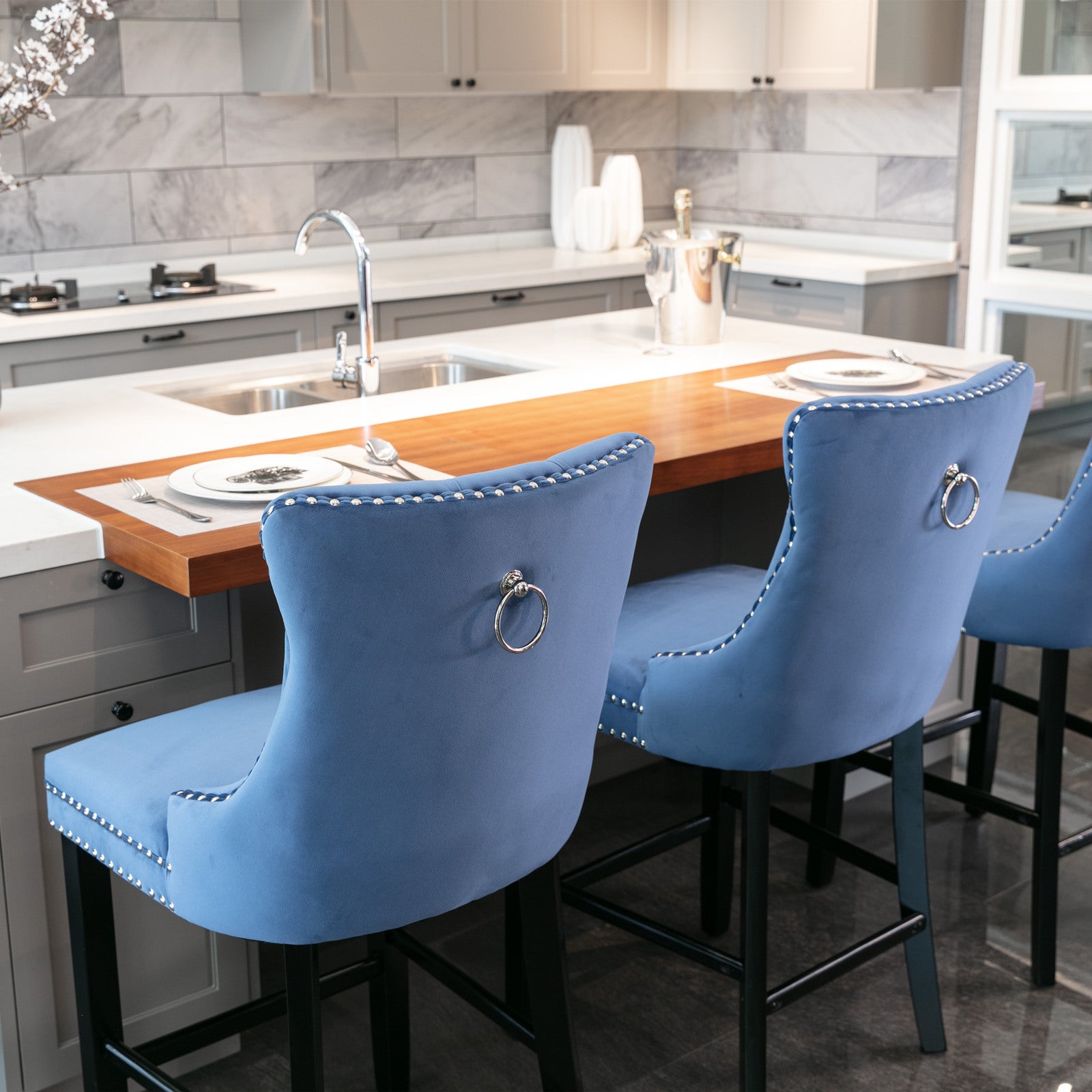 Blue velvet bar stool with silver nailhead trim and ring pull detail