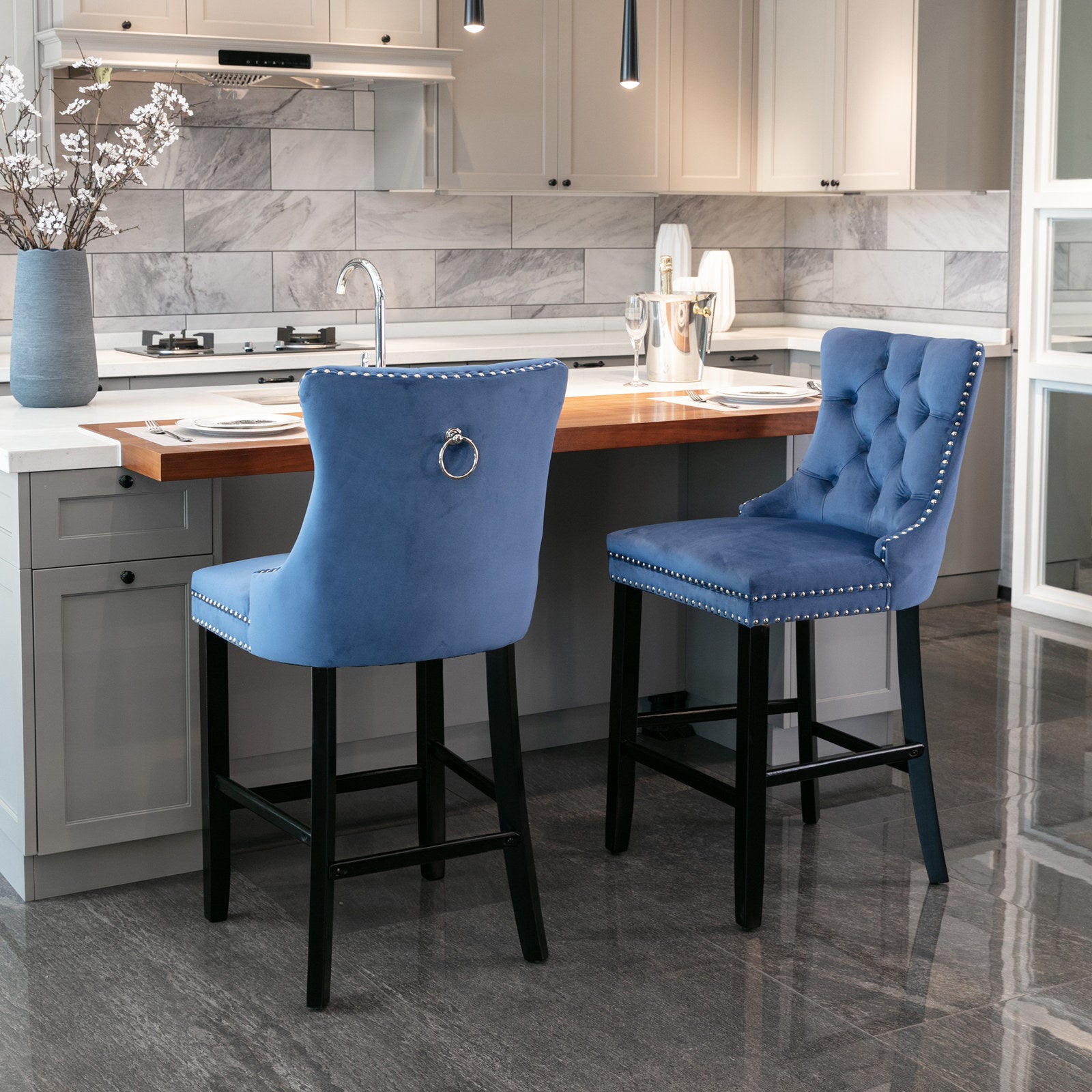 Blue velvet tufted bar stool with silver nailhead trim and ring accent