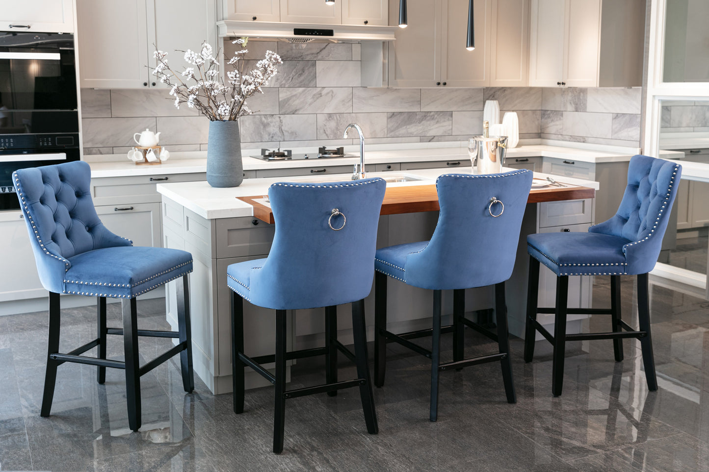 Blue velvet tufted bar stool with silver nailhead trim and ring accent