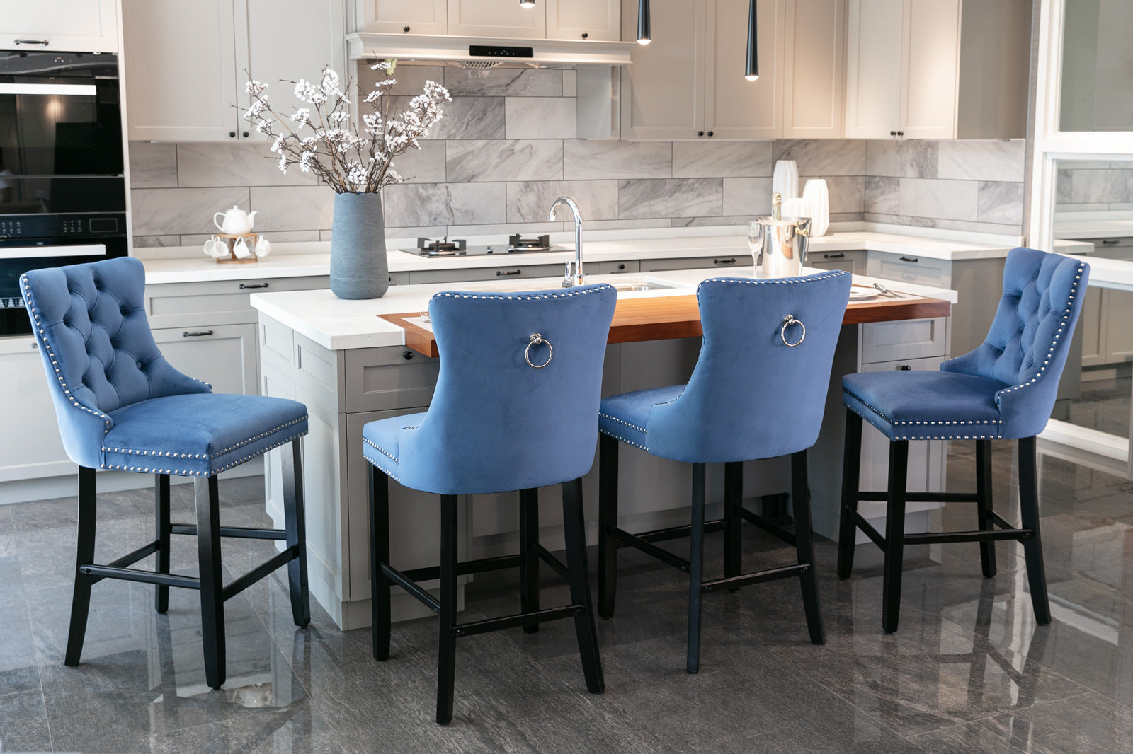 Blue velvet tufted bar stool with silver nailhead trim and ring accent