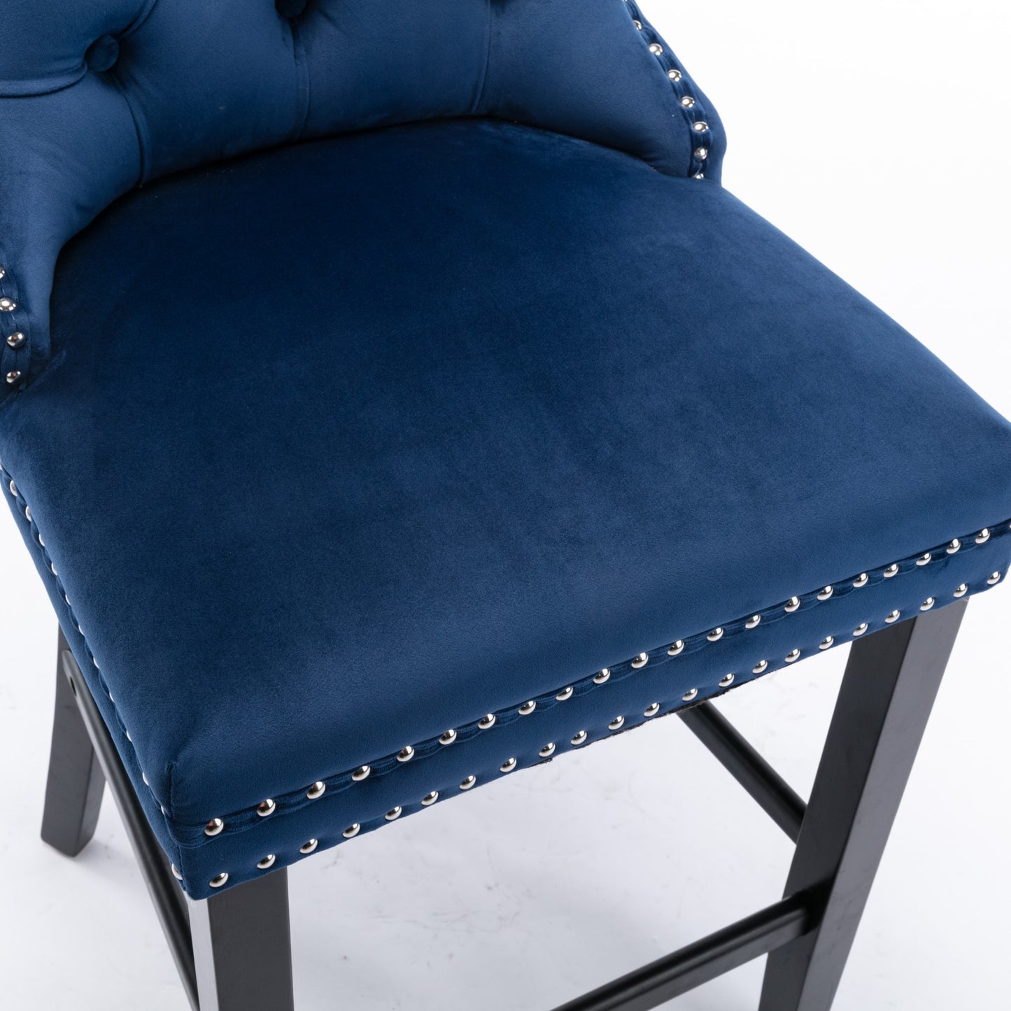 Deep blue velvet bar stool with silver nailhead trim and tufted back