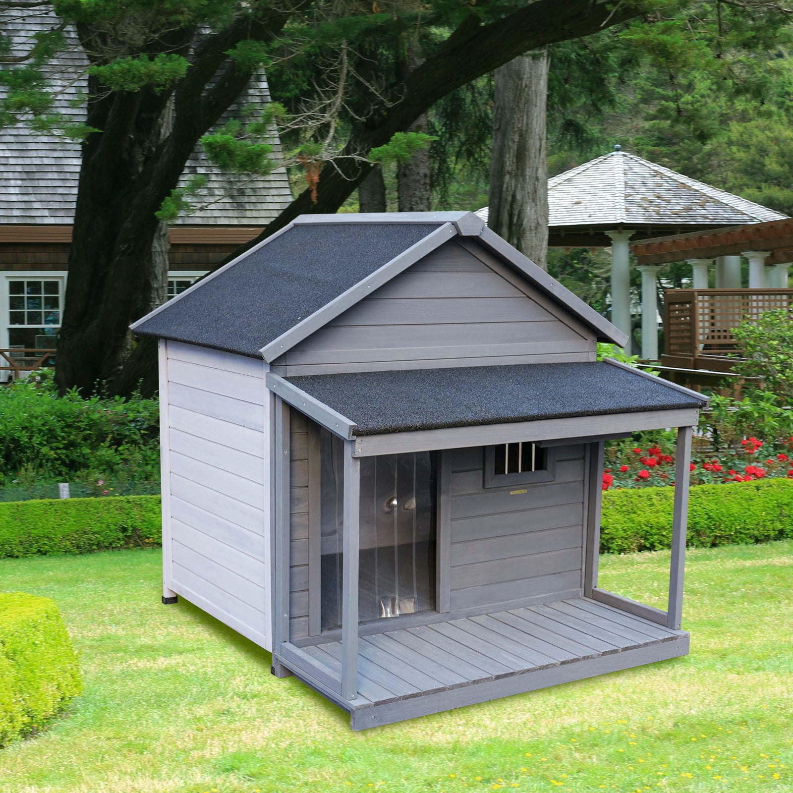 Gray wooden dog house with porch and peaked roof