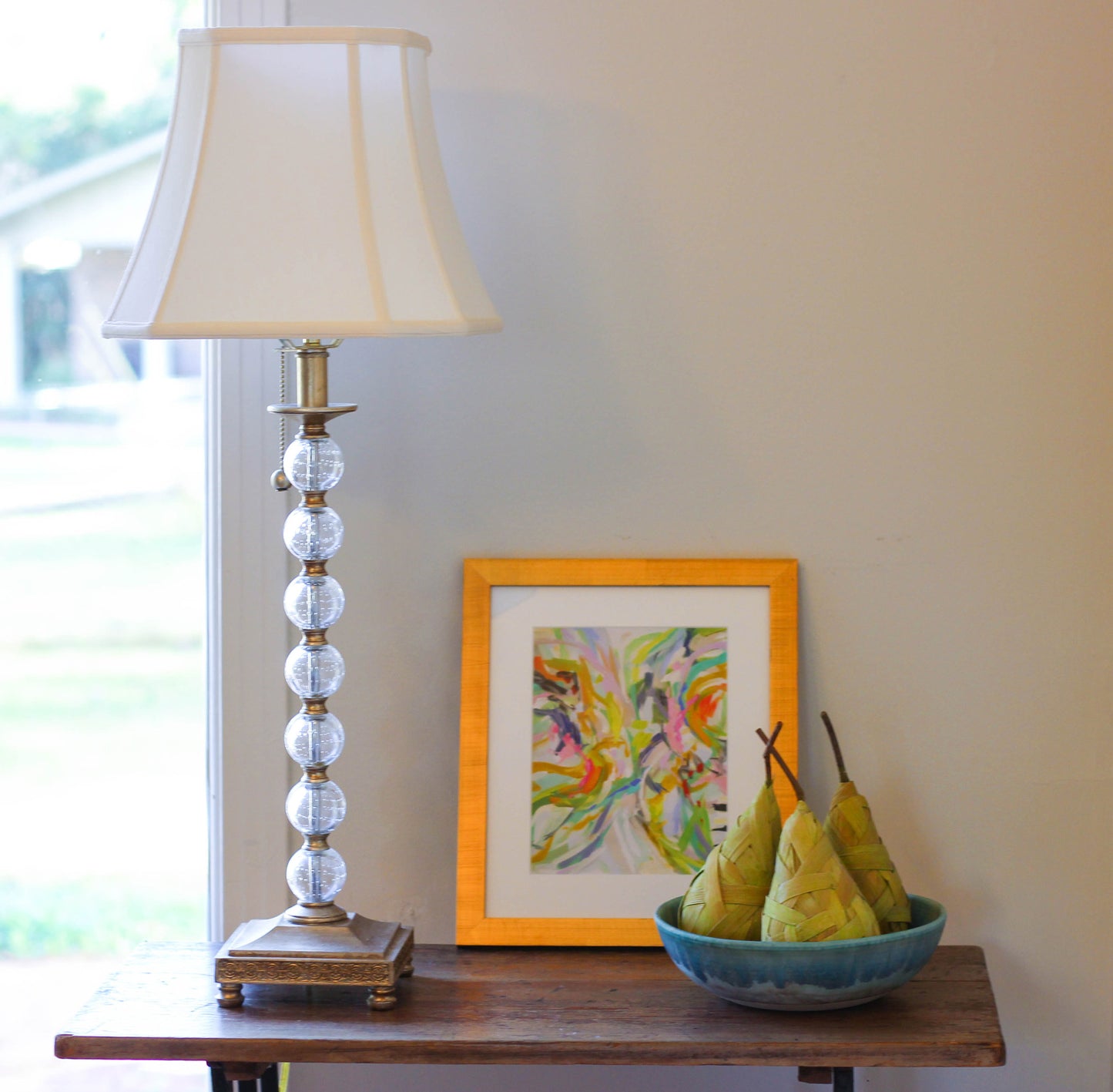 Classic brass table lamp with crystal accents and a white linen shade
