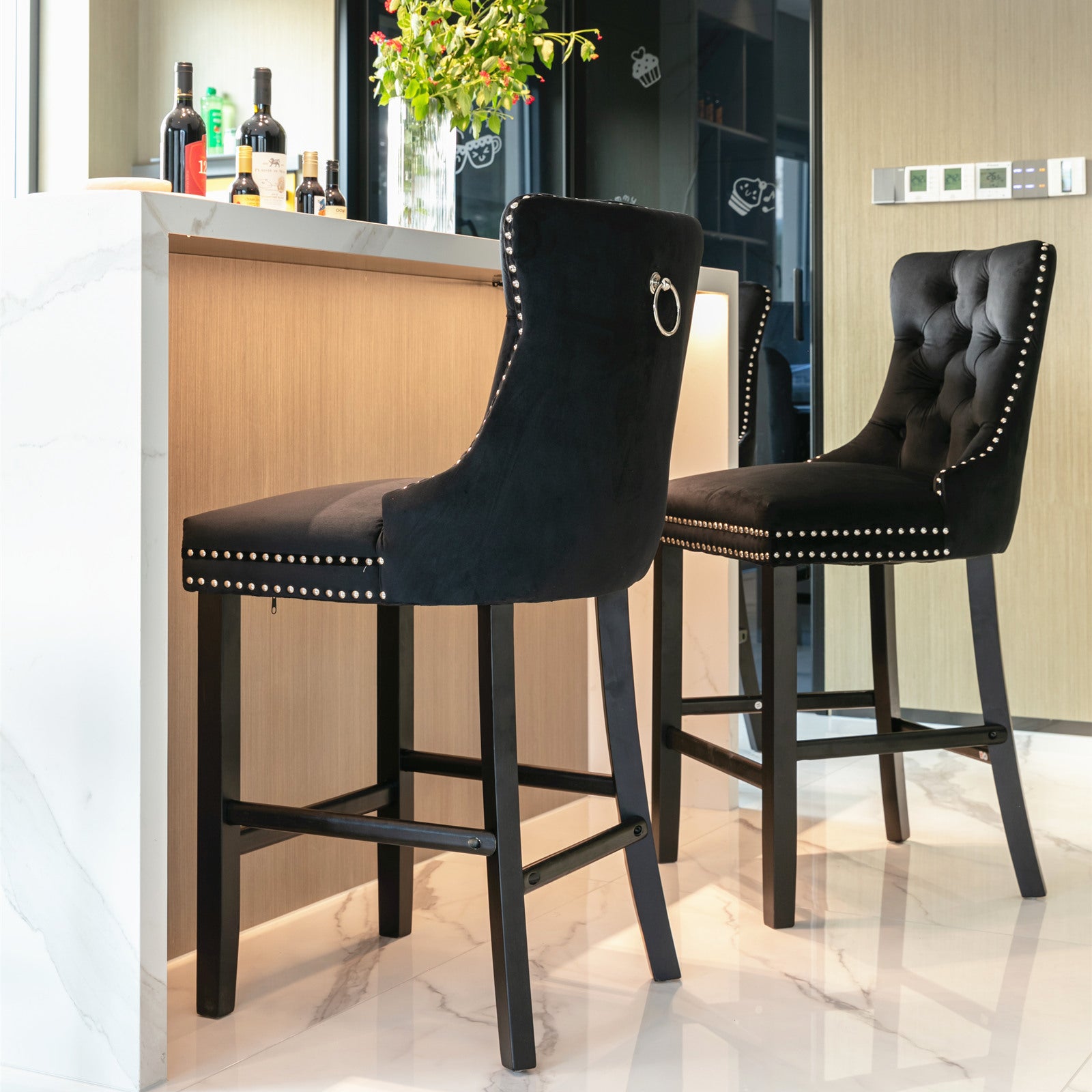Black velvet bar stool with silver nailhead trim and ring pull