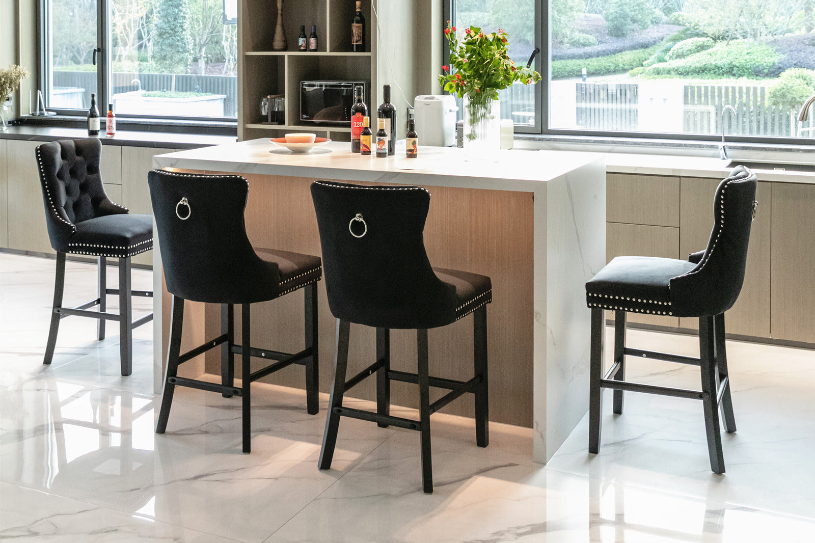 Black velvet tufted bar stool with silver nailhead trim and ring accent