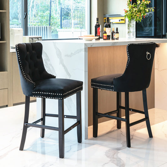 Black velvet tufted bar stool with silver nailhead trim and ring pull accent