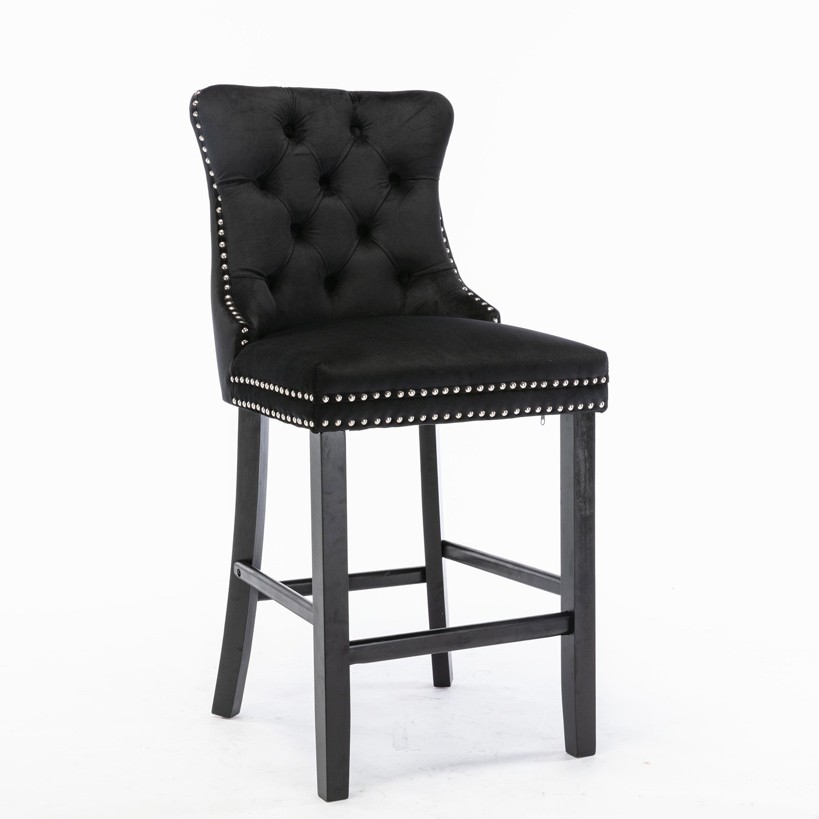 Black velvet tufted bar stool with silver nailhead trim and dark wood legs