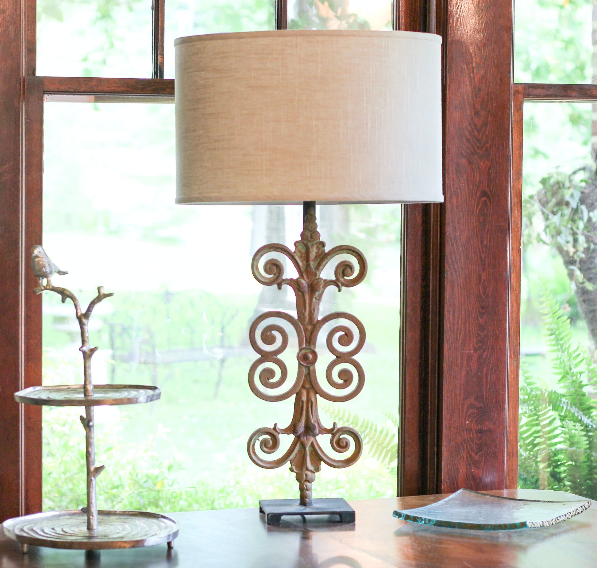 Ornate scrollwork table lamp with linen shade