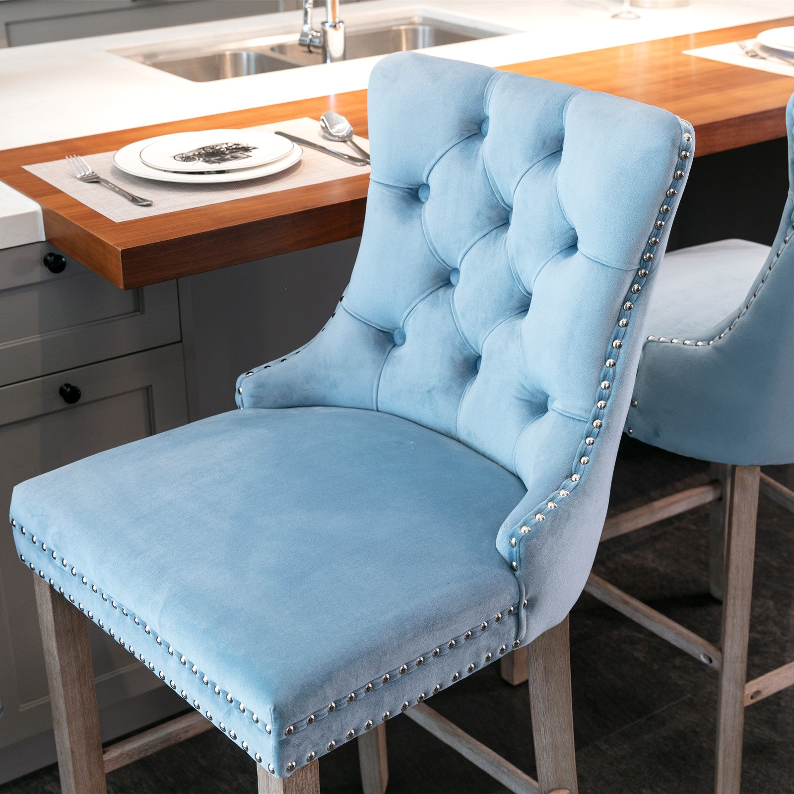 Sky blue velvet tufted bar stool with silver nailhead trim