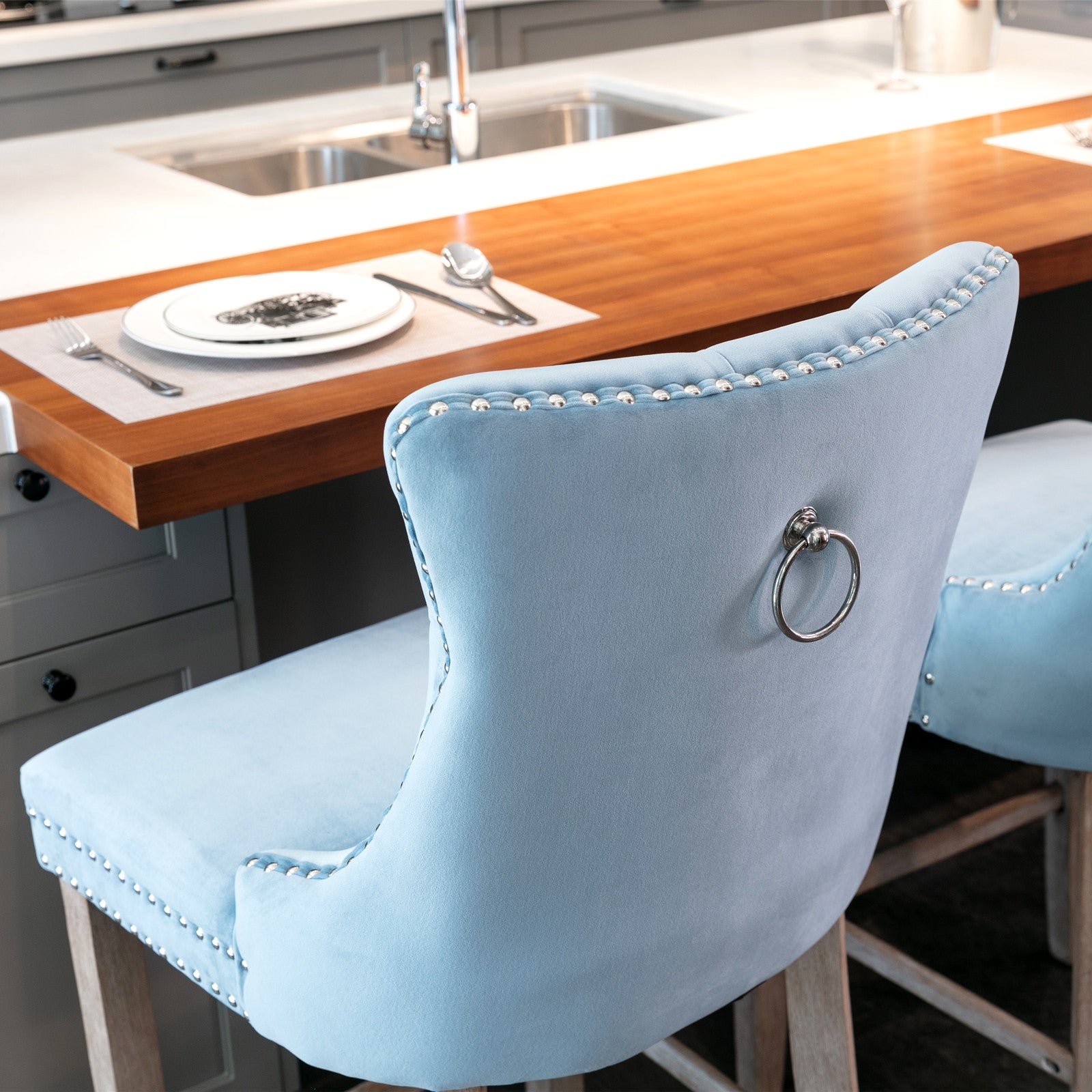 Light blue velvet bar stool with silver nailhead trim and ring pull accent