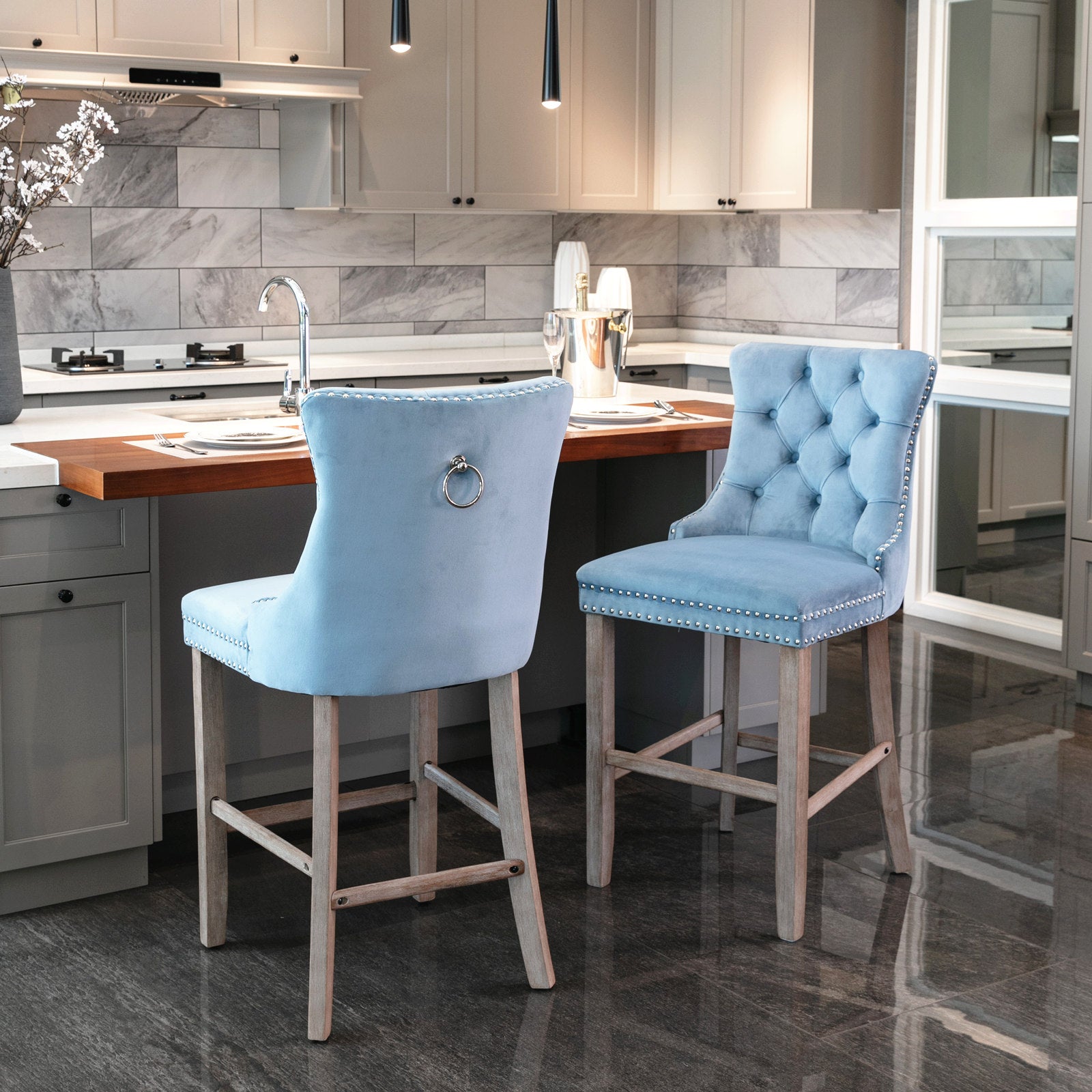 Light blue velvet tufted bar stool with silver nailhead trim and ring back