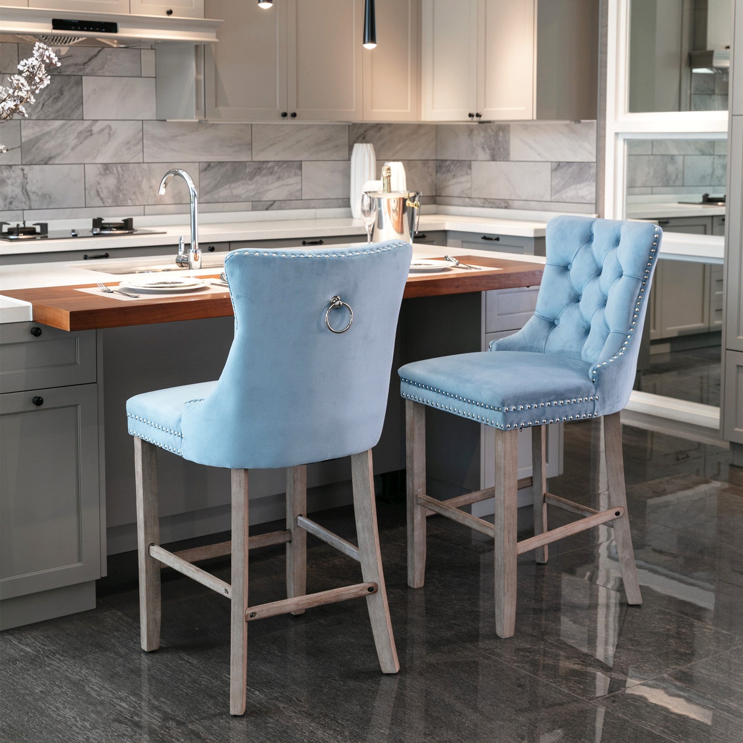 Light blue velvet bar stool with tufted back and silver nailhead trim