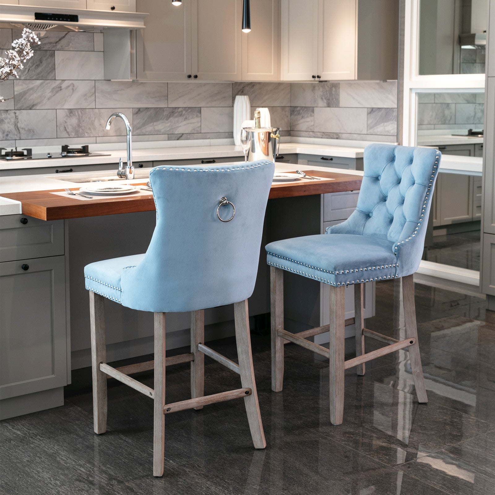 Light blue velvet bar stool with tufted back and silver nailhead trim