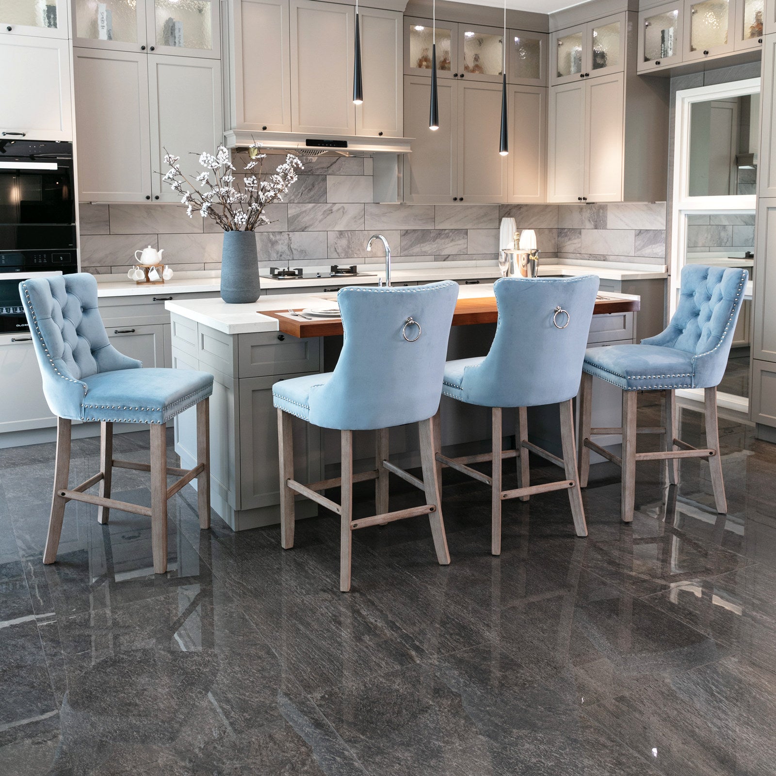 Light blue tufted velvet bar stool with silver nailhead trim and ring back