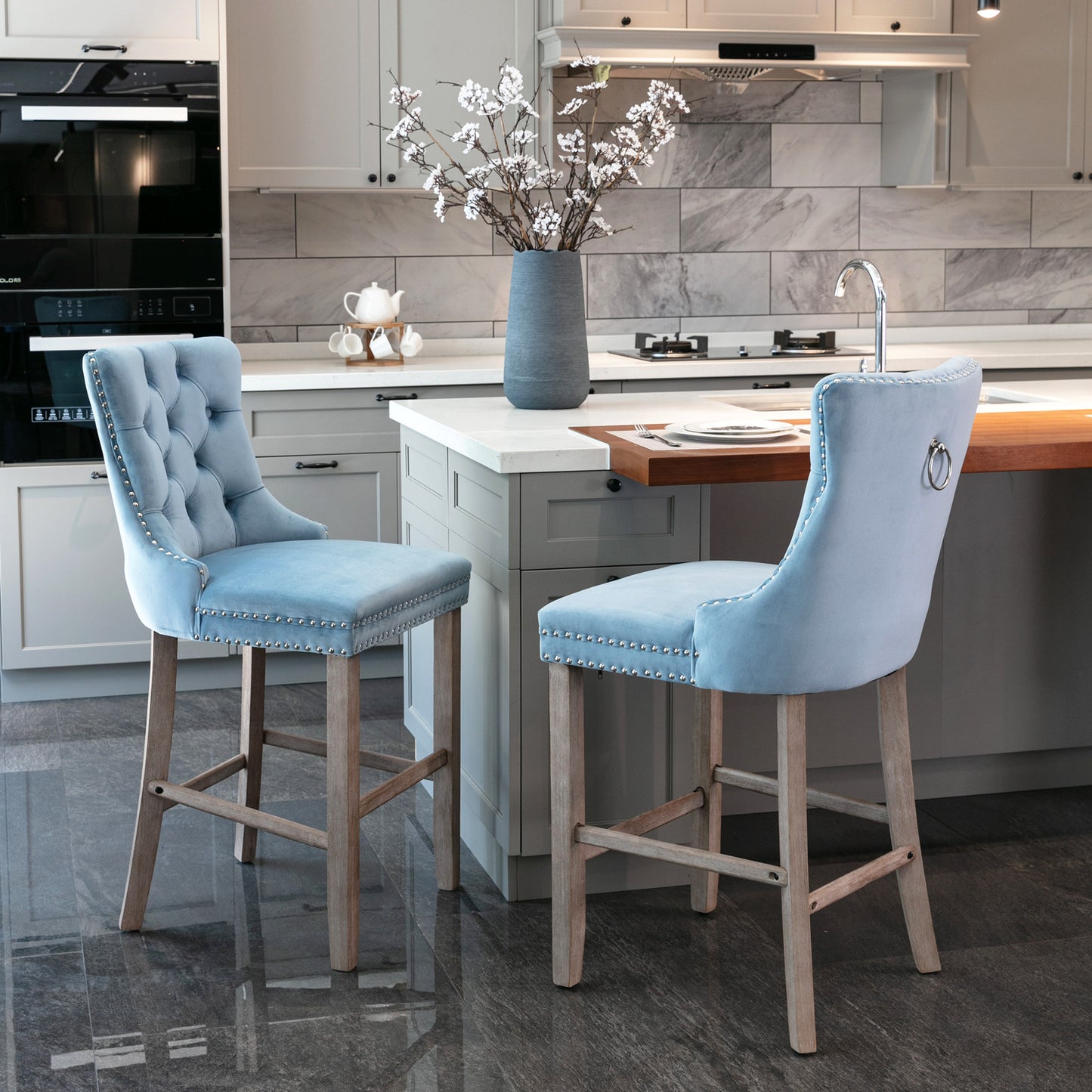 Light blue velvet tufted bar stool with silver nailhead trim and ring detail