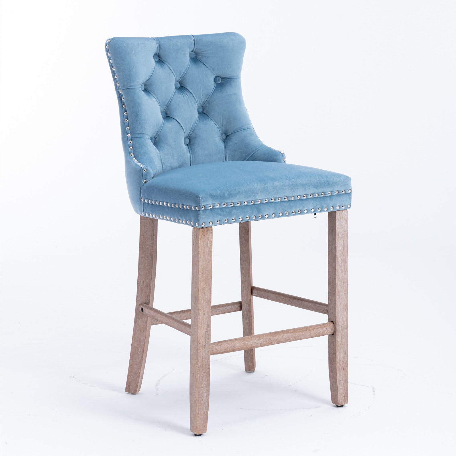 Light blue velvet tufted bar stool with silver nailhead trim and wooden legs