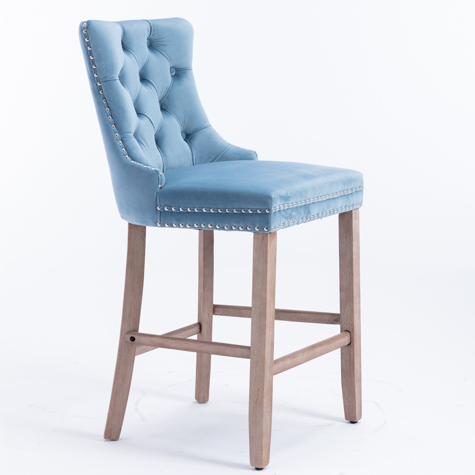 Light blue velvet tufted bar stool with silver nailhead trim and light wood legs