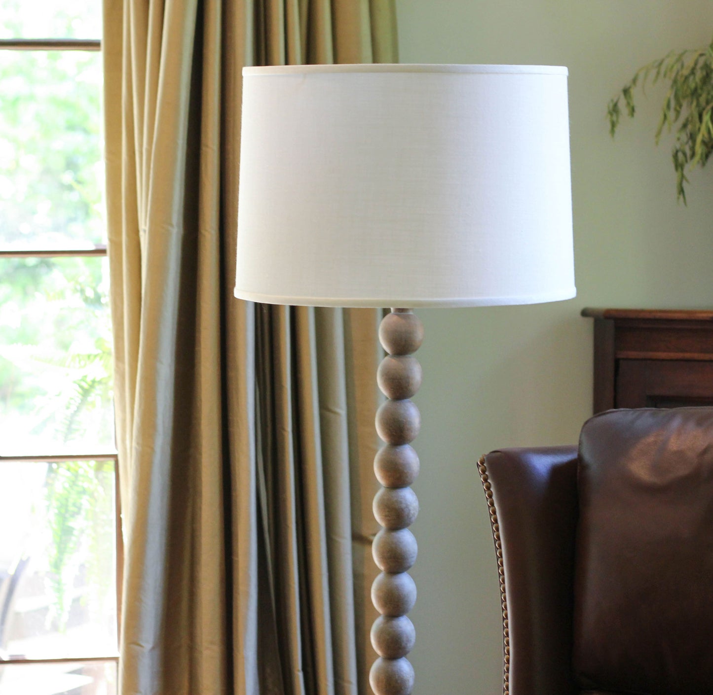 Beadedbase floor lamp with cream shade in neutral living room