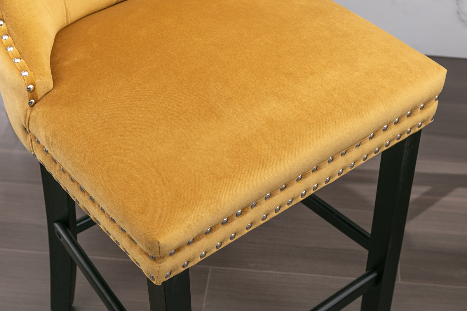 Yellow velvet bar stool with silver nailhead trim and black legs