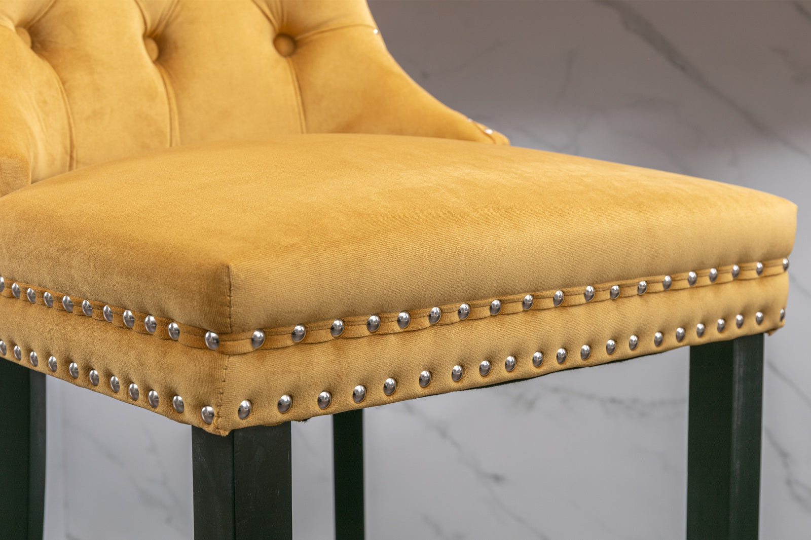 Gold velvet bar stool with button tufted back and silver nailhead trim