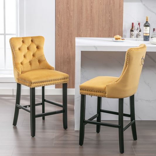 Tufted mustard yellow velvet bar stool with silver nailhead trim
