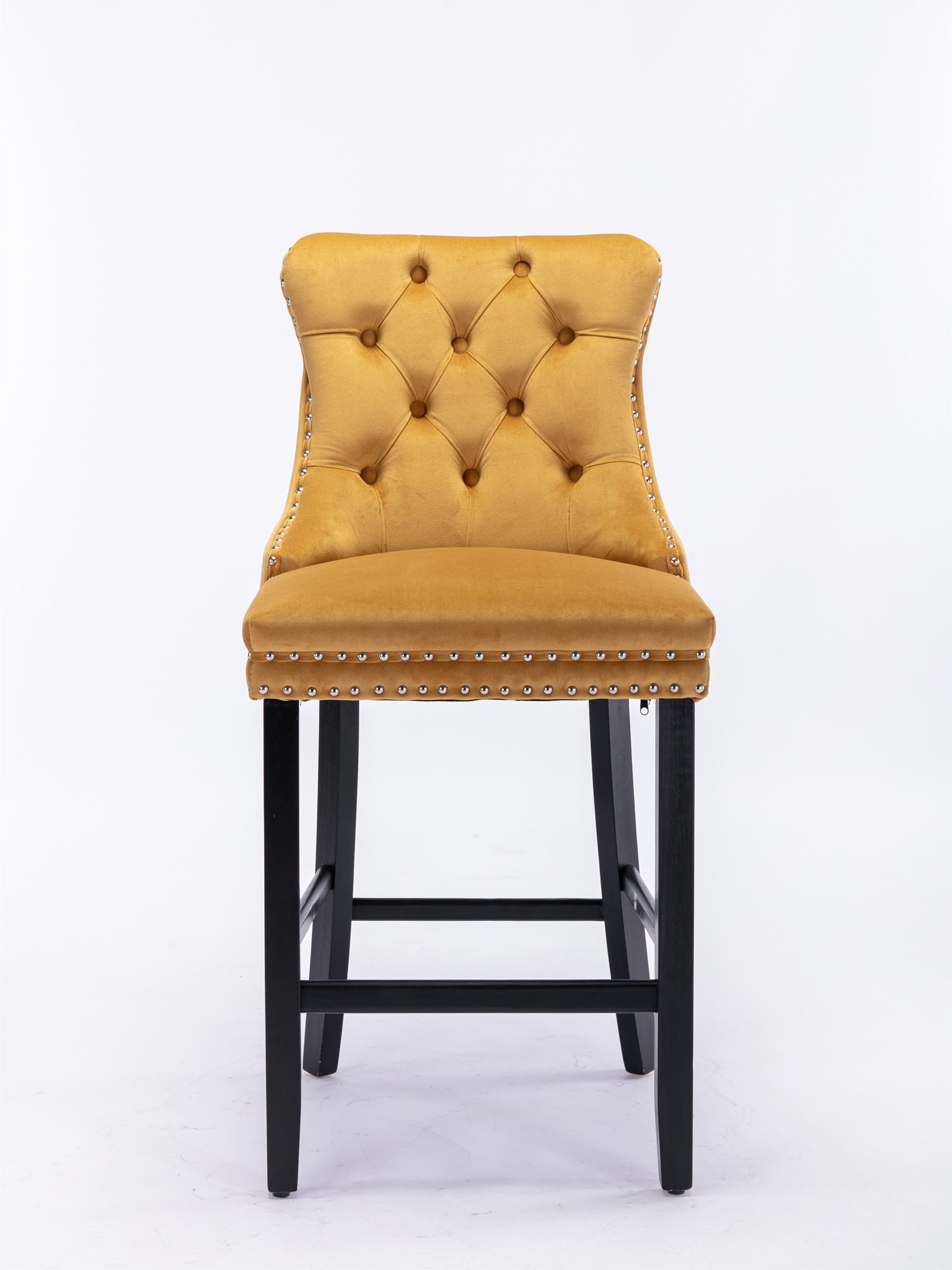 Tufted mustard velvet bar stool with silver nailhead trim and black wooden legs