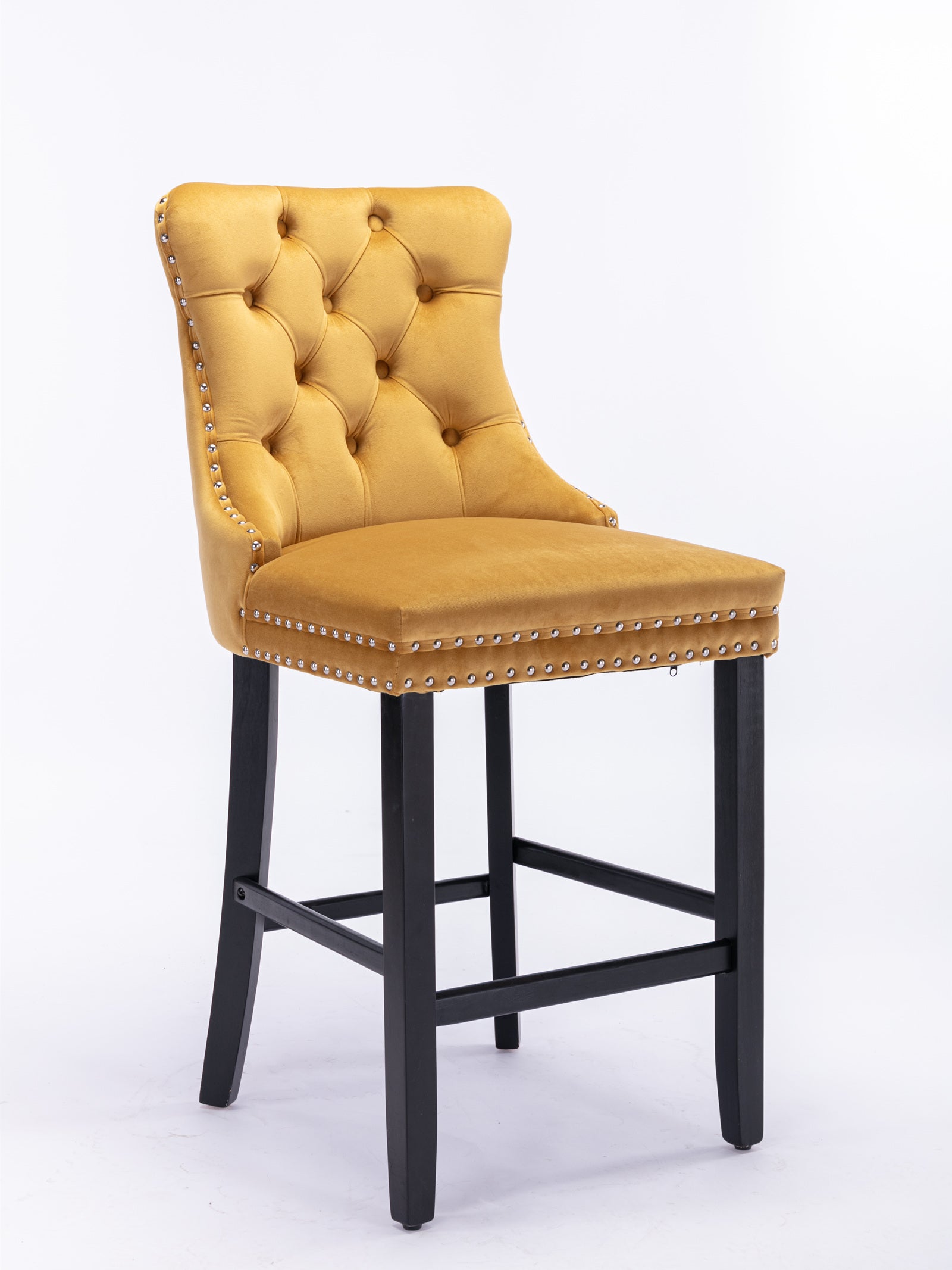 Tufted mustard velvet bar stool with silver nailhead trim and black wooden legs
