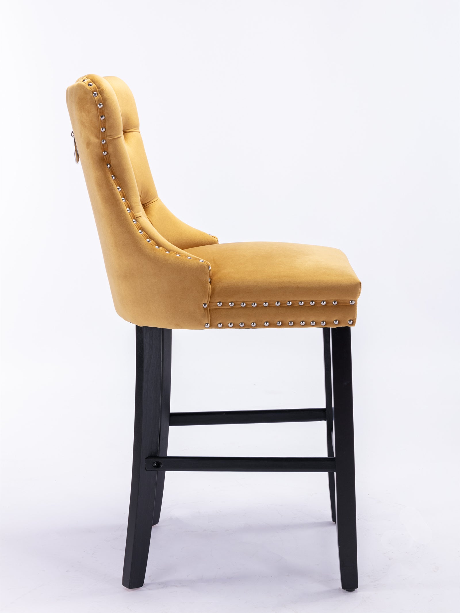 Yellow velvet bar stool with silver nailhead trim and black wooden legs