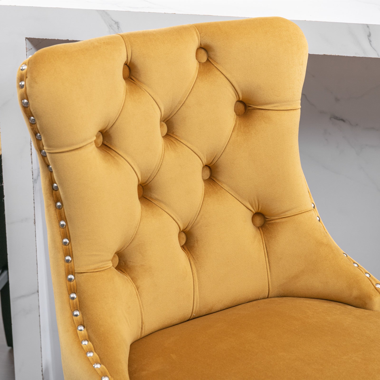 Yellow velvet accent chair with tufted back and nailhead trim