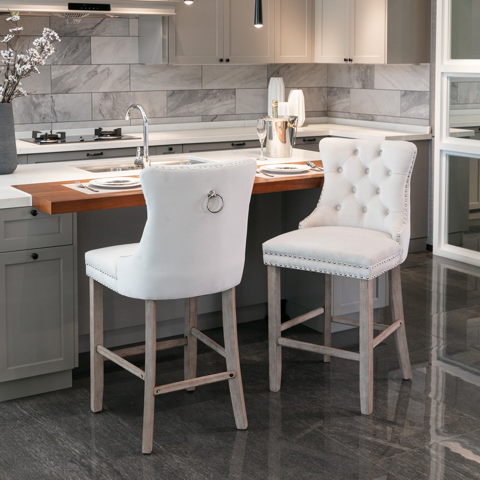 White velvet tufted bar stool with silver nailhead trim and ring pull accent