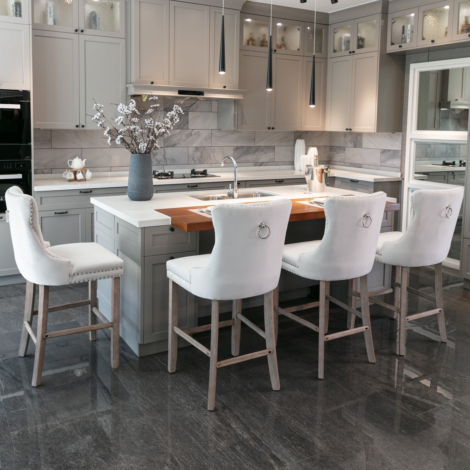 White upholstered bar stool with silver nailhead trim and ring pull
