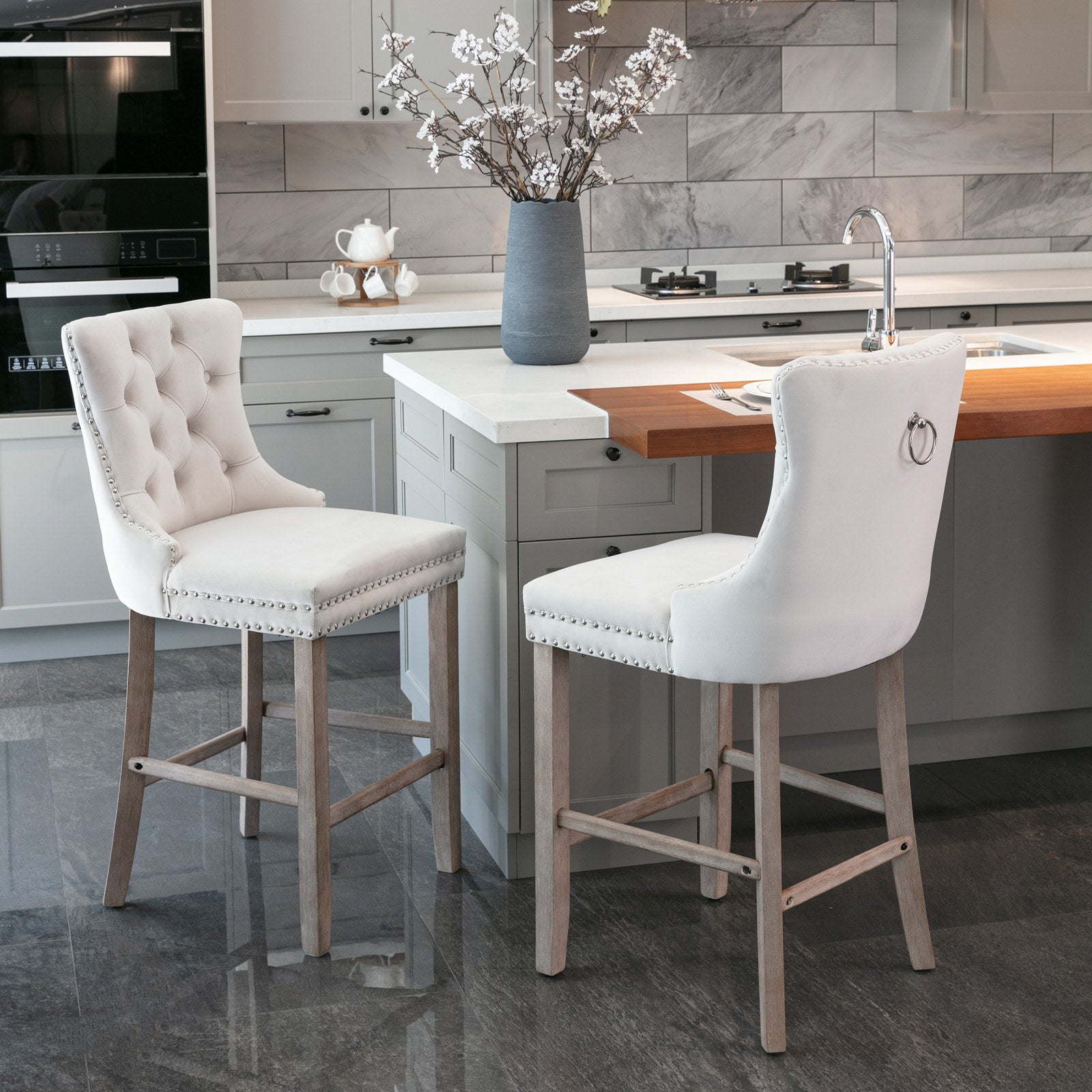 Tufted cream fabric bar stool with silver nailhead trim and light wood legs
