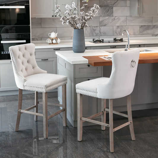 Tufted cream fabric bar stool with silver nailhead trim and light wood legs