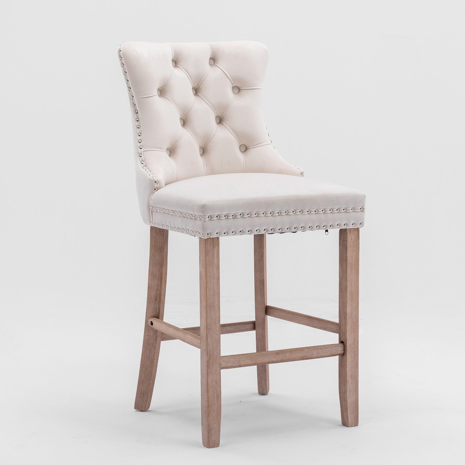 Elegant tufted cream velvet bar stool with nailhead trim and a distressed wood base