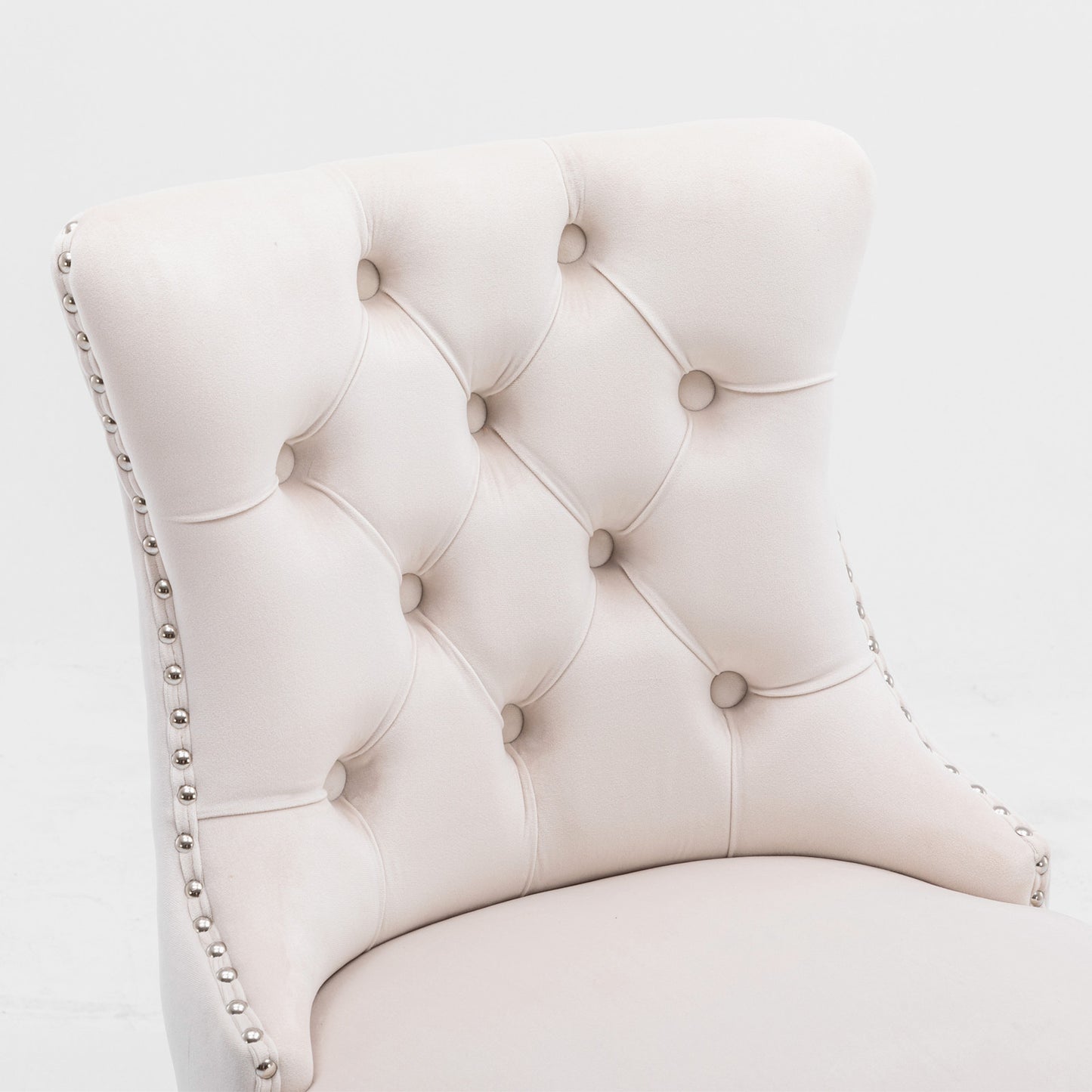Cream velvet dining chair with tufted back and nailhead trim