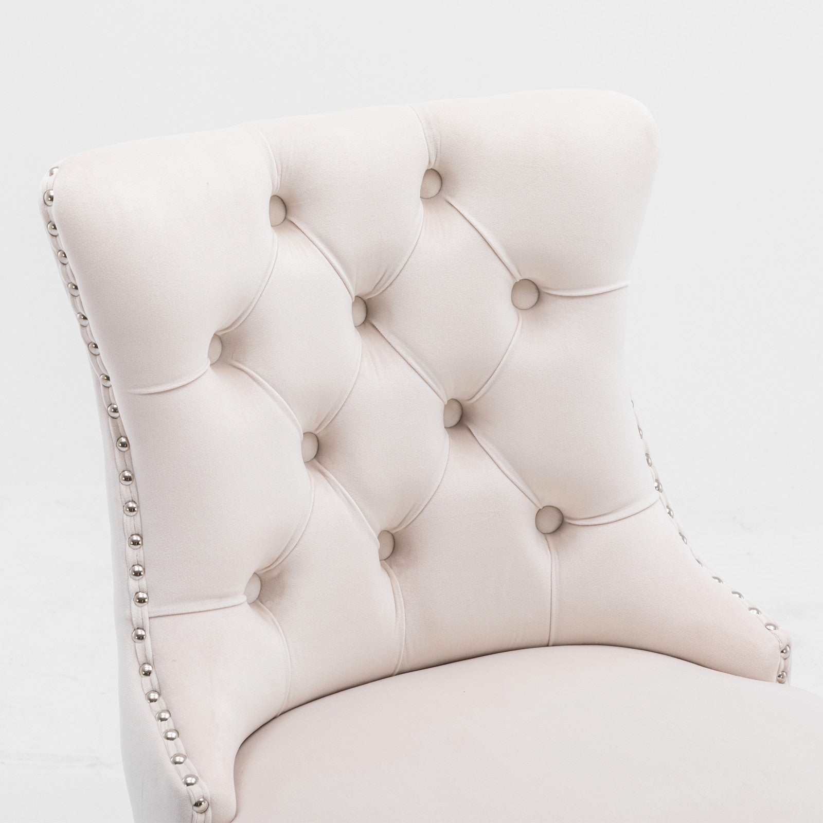 Cream velvet dining chair with tufted back and nailhead trim