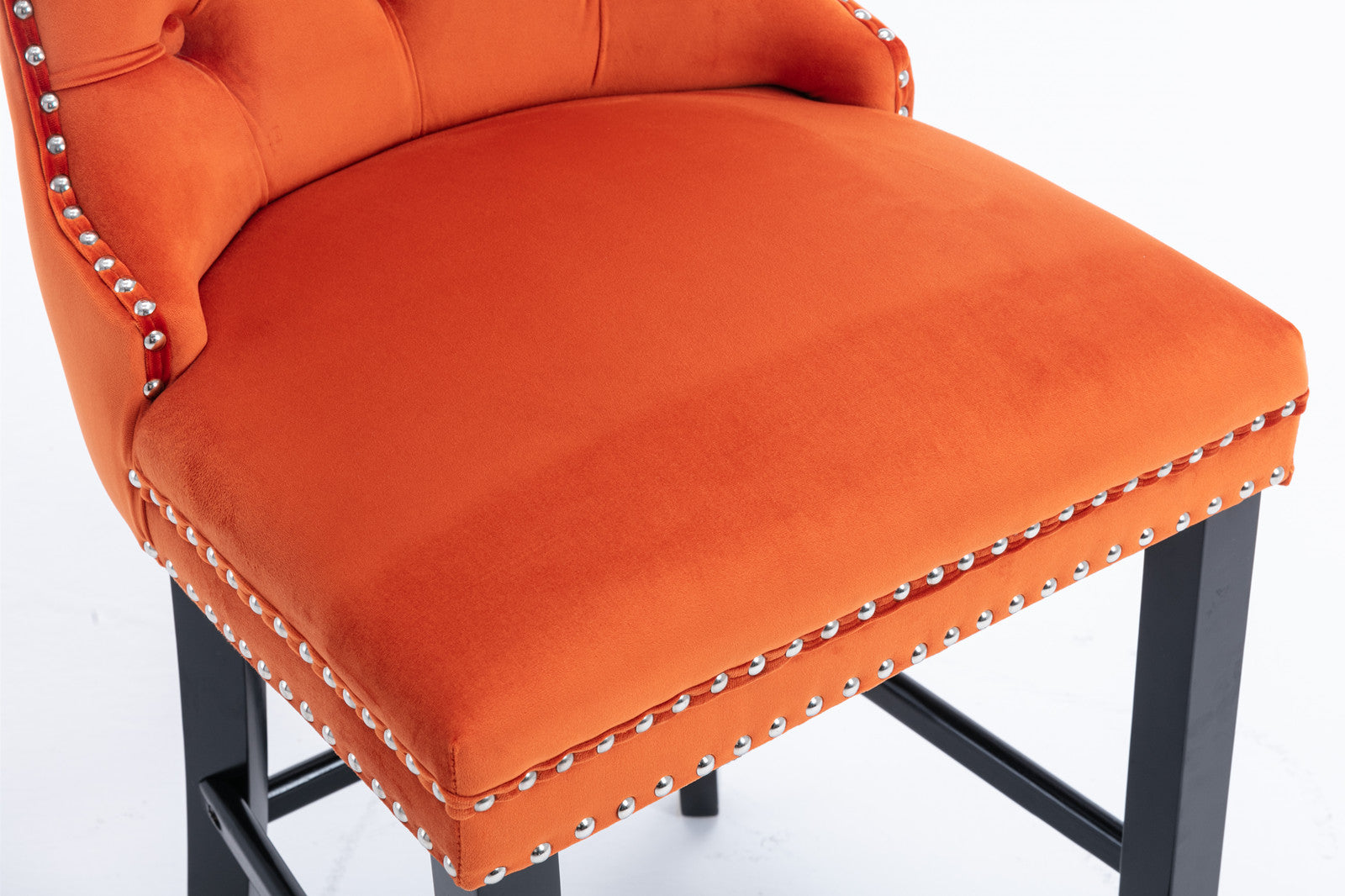 Orange velvet bar stool with tufted back and nailhead trim