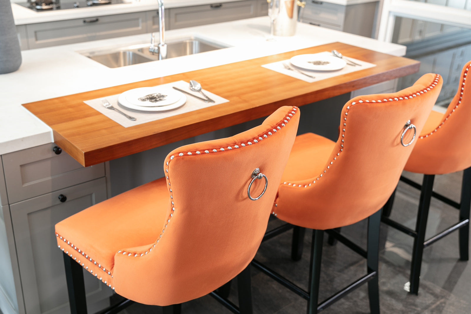 Orange velvet bar stool with silver nailhead trim and ring pull