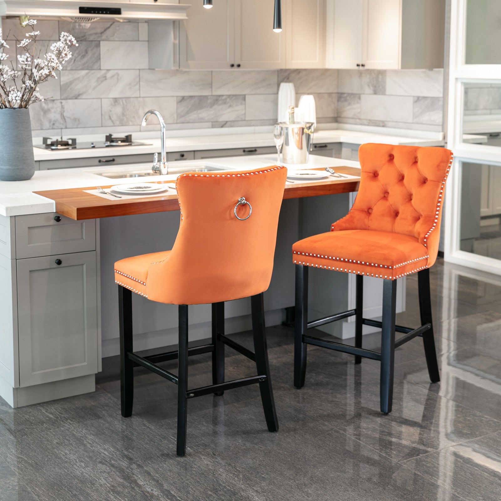 Tufted orange velvet bar stool with silver nailhead trim and ring pull