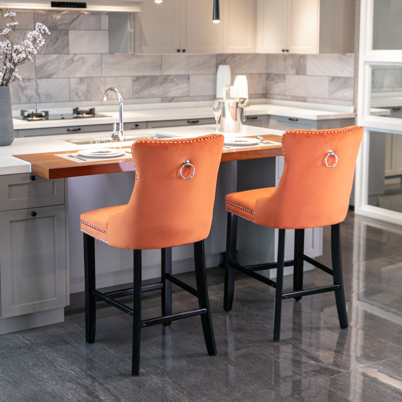 Orange velvet bar stool with silver nailhead trim and ring pull