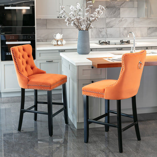 Orange velvet tufted bar stool with silver nailhead trim and ring accent