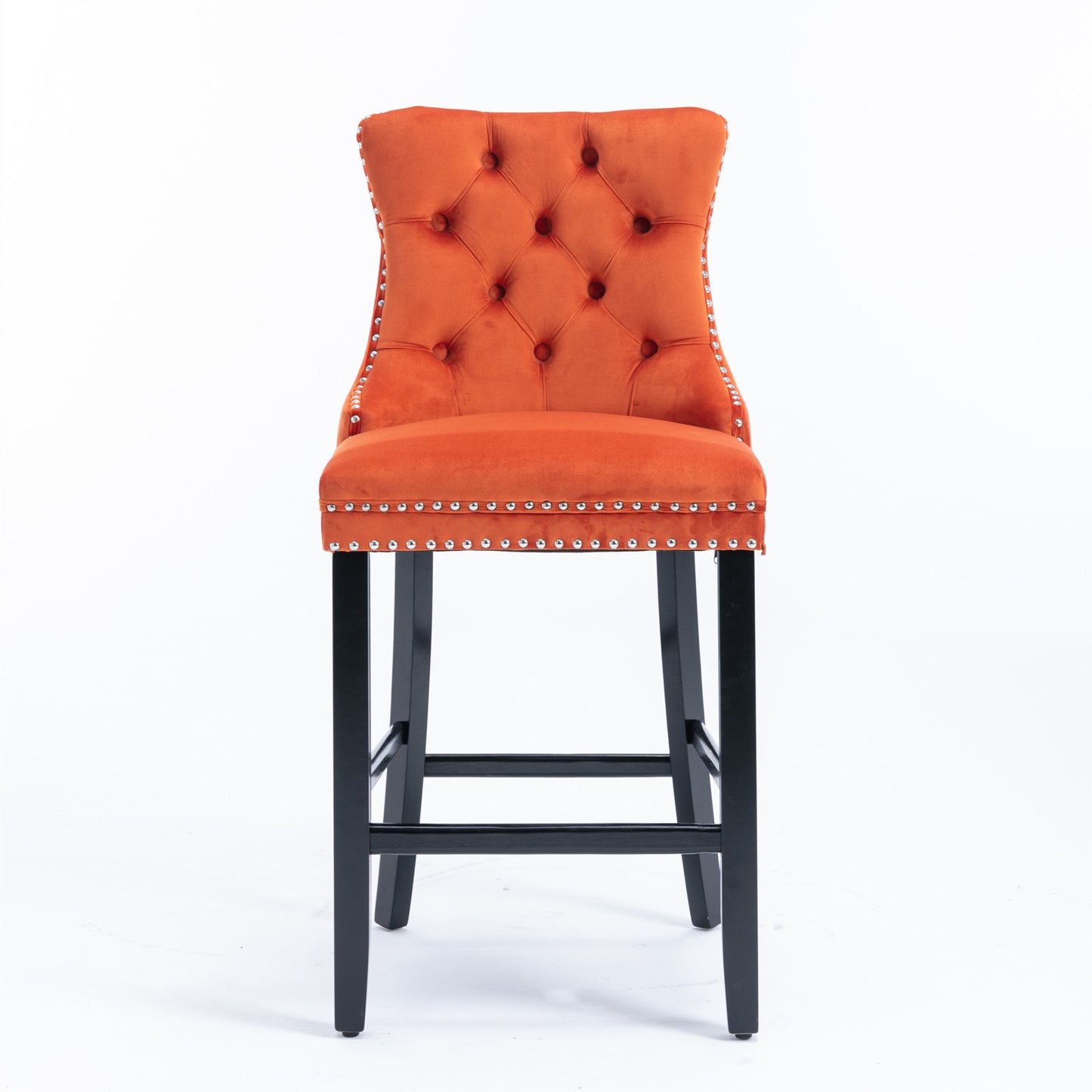 Orange velvet tufted bar stool with silver nailhead trim and black wooden legs
