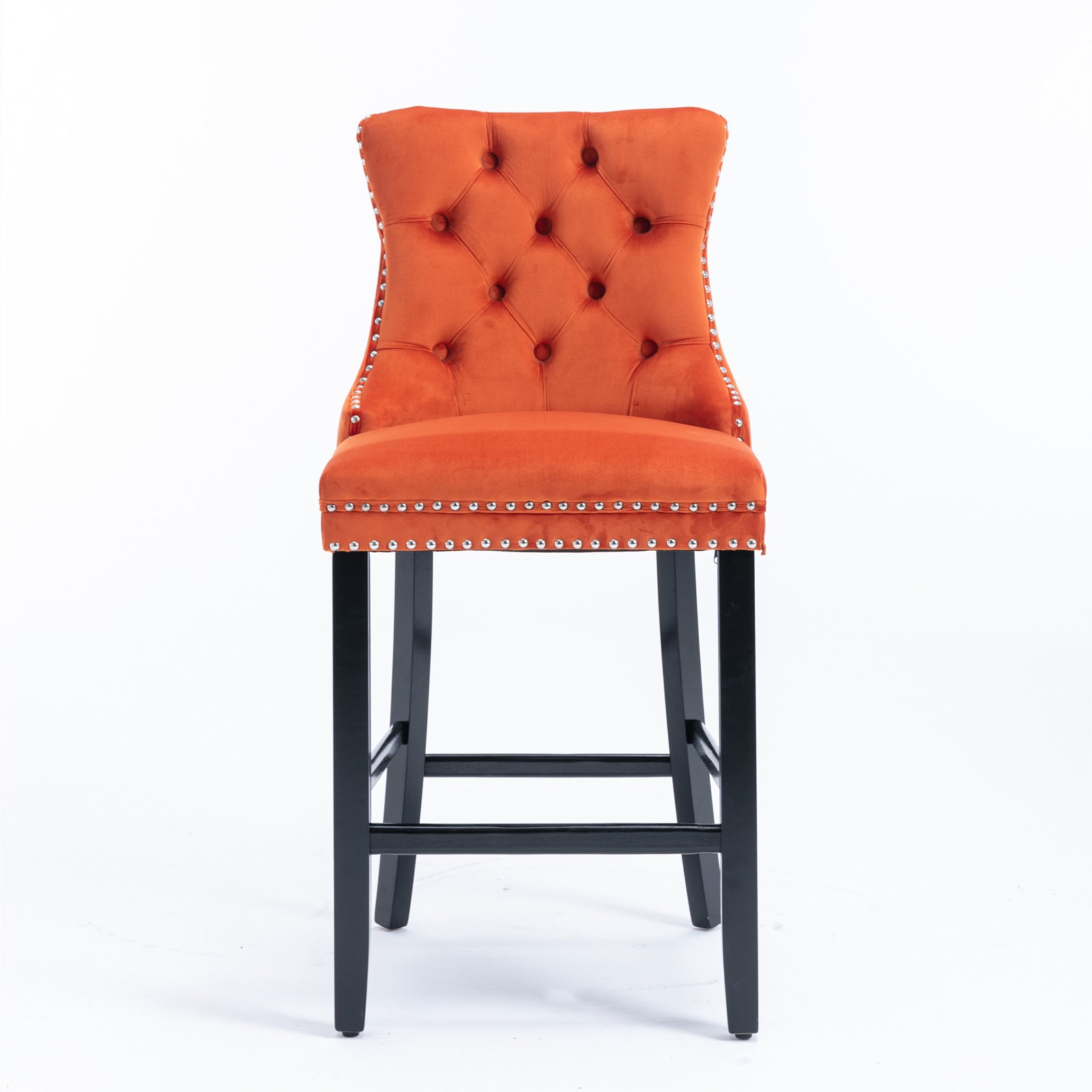 Orange velvet tufted bar stool with silver nailhead trim and black wooden legs