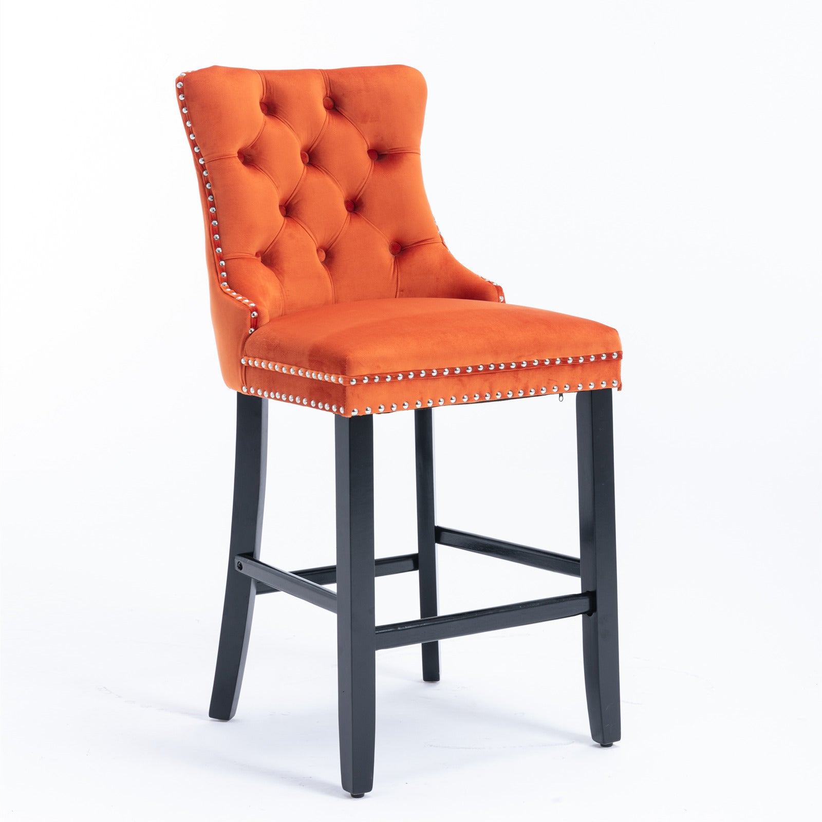 Orange velvet tufted bar stool with silver nailhead trim and dark wood legs