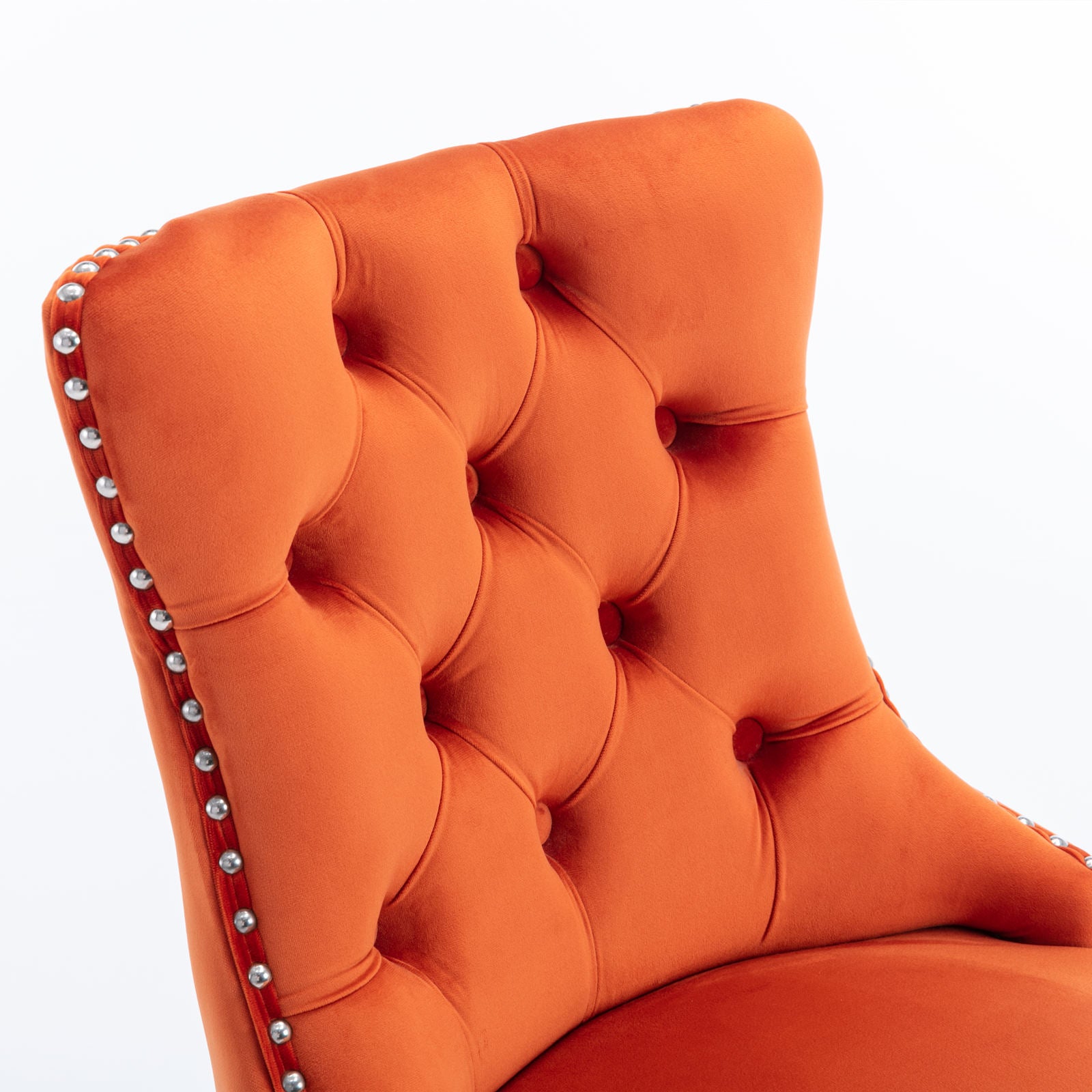 Orange velvet tufted accent chair with silver nailhead trim